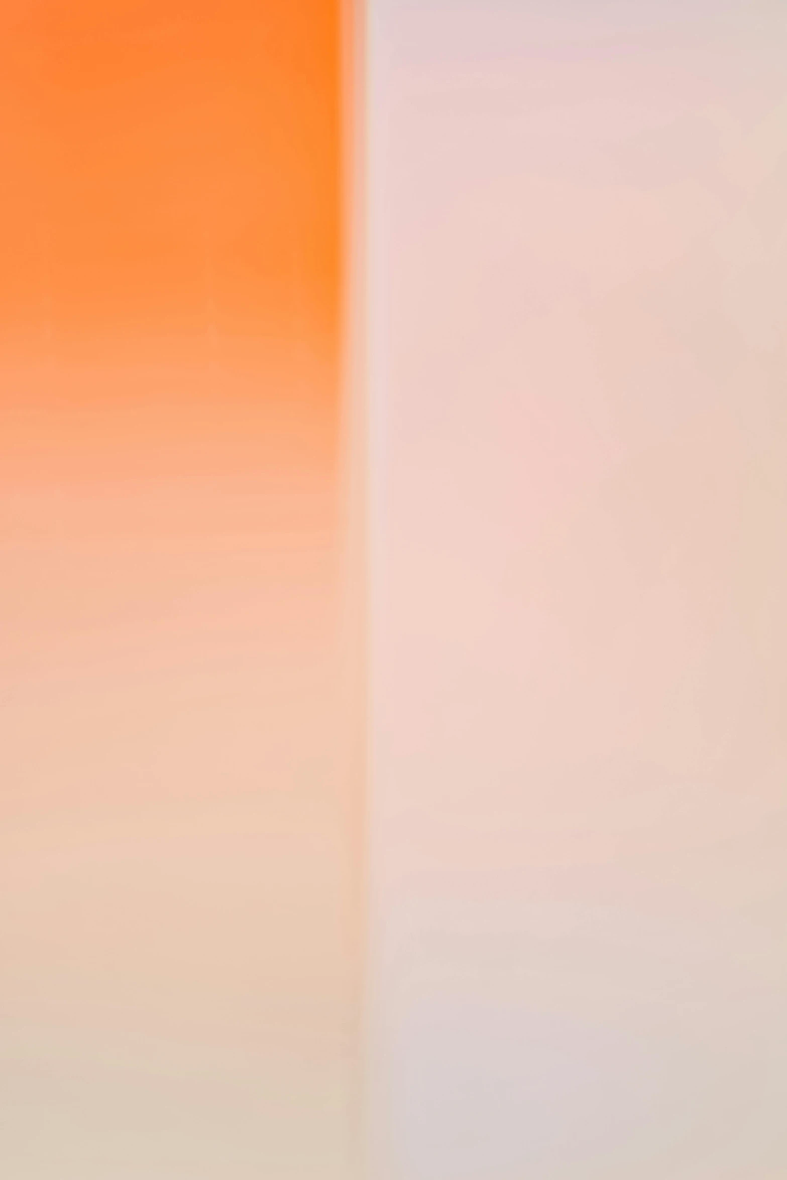 a white toilet sitting in a bathroom next to a wall, a picture, inspired by Barnett Newman, unsplash, color field, gradient orange, blurred detail, 2011, refracted sunset