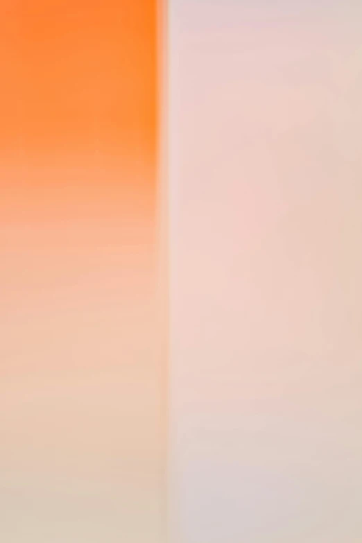 a white toilet sitting in a bathroom next to a wall, a picture, inspired by Barnett Newman, unsplash, color field, gradient orange, blurred detail, 2011, refracted sunset