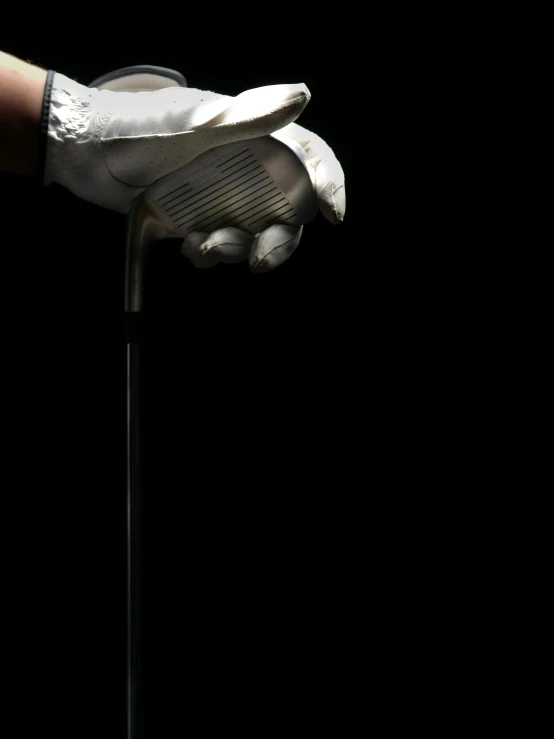 a close up of a person's hand holding a golf club, by John Hutton, conceptual art, white on black, thumbnail, sport, demur