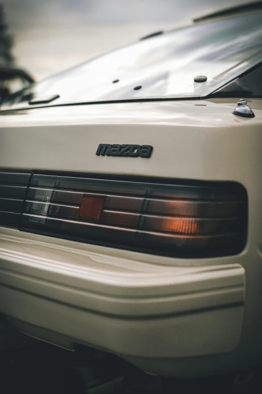 a white car parked in a parking lot, a picture, by Matt Cavotta, unsplash, tail lights, iroc, medium closeup, very hazy