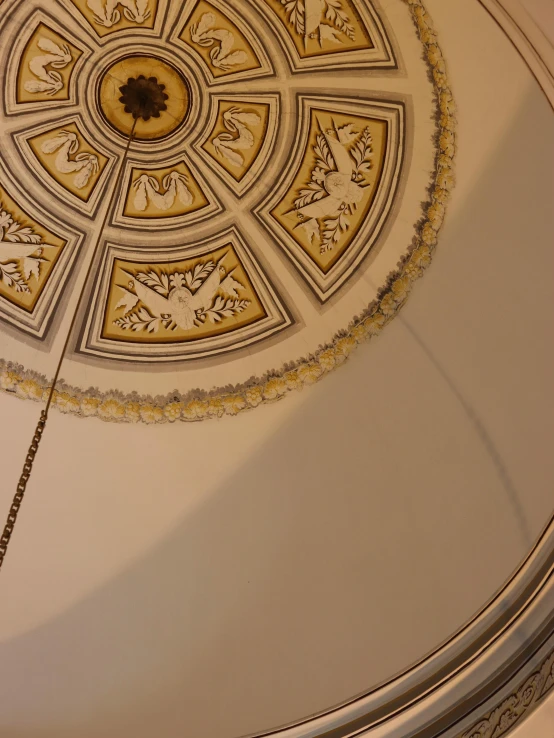 a clock mounted to the ceiling of a building, a detailed painting, inspired by Carlo Crivelli, trending on reddit, detail studio quality lighting, kintsugi!!, mosque synagogue interior, white ceiling