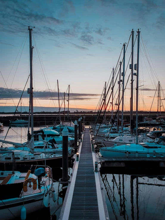 a dock filled with lots of boats sitting next to each other, a picture, pexels contest winner, happening, magic hour lighting, thumbnail, low quality photo, lachlan bailey