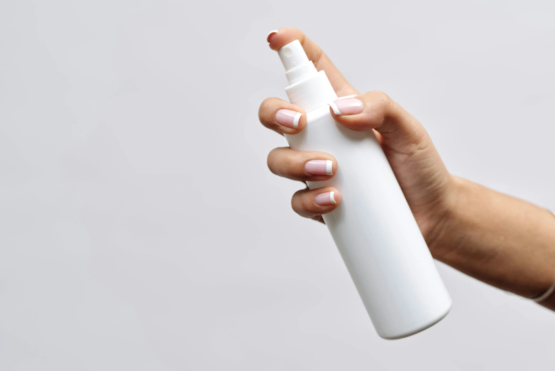 a woman's hand holding a white spray bottle, trending on pexels, flat, beautifully rendered, without text, hair fluid