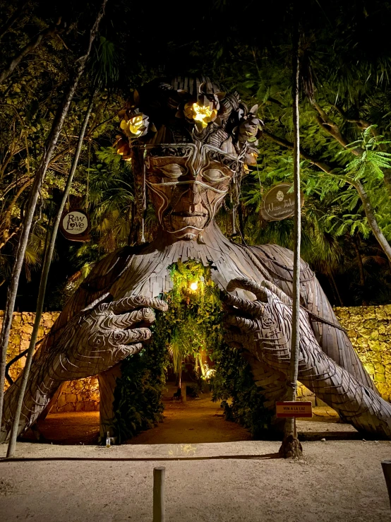 a statue of a man sitting on a swing, in a deep lush jungle at night, giant aztec space city, driftwood sculpture, gorgeous and huge head ornaments