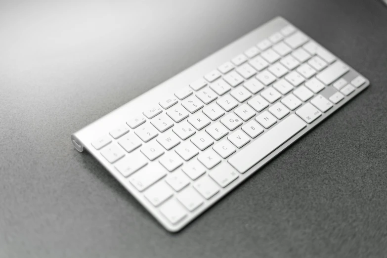 a computer keyboard sitting on top of a desk, by Matija Jama, pexels, computer art, white shiny skin, square, tileable, aluminum