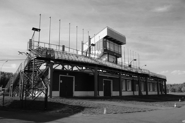 a black and white photo of a building, at circuit de spa francorchamps, in empty!!!! legnica, high quality upload, square