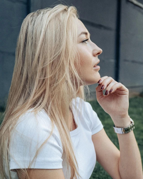 a woman sitting in the grass smoking a cigarette, inspired by Elsa Bleda, trending on unsplash, happening, wearing a watch, profile putin, dressed in a white t-shirt, platinum blonde hair