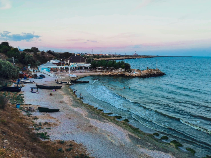 a group of boats sitting on top of a sandy beach, a photo, black sea, which shows a beach at sunset, flatlay, cyprus