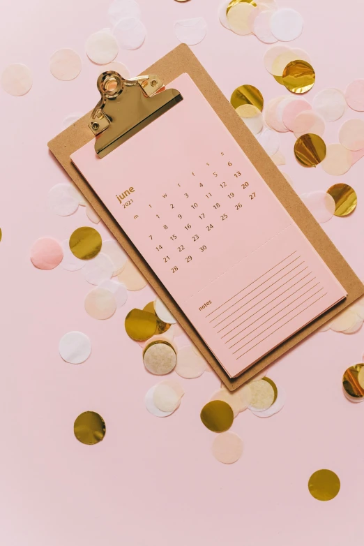 a calendar on a clipboard surrounded by confetti, by Julia Pishtar, trending on unsplash, pink and gold color scheme, thumbnail, ready to model, intricately defined