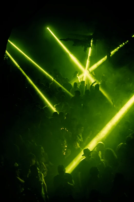 a group of people that are standing in the dark, vivid green lasers, ibiza, down there, dusty lighting