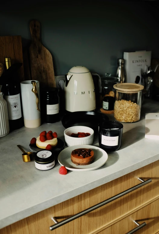 a counter top with a plate of food on it, a still life, inspired by Richmond Barthé, unsplash, large sweet jars on shelves, products shot, raspberry, molten