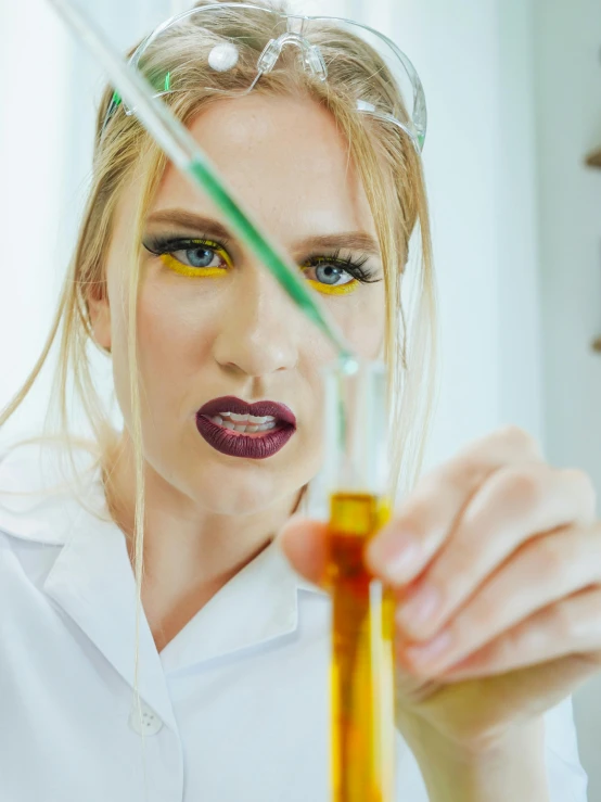 a woman in a lab coat holding a test tube, inspired by Hedi Xandt, trending on pexels, analytical art, yellow makeup, blonde crea, oil slick, a wizard's apothecary