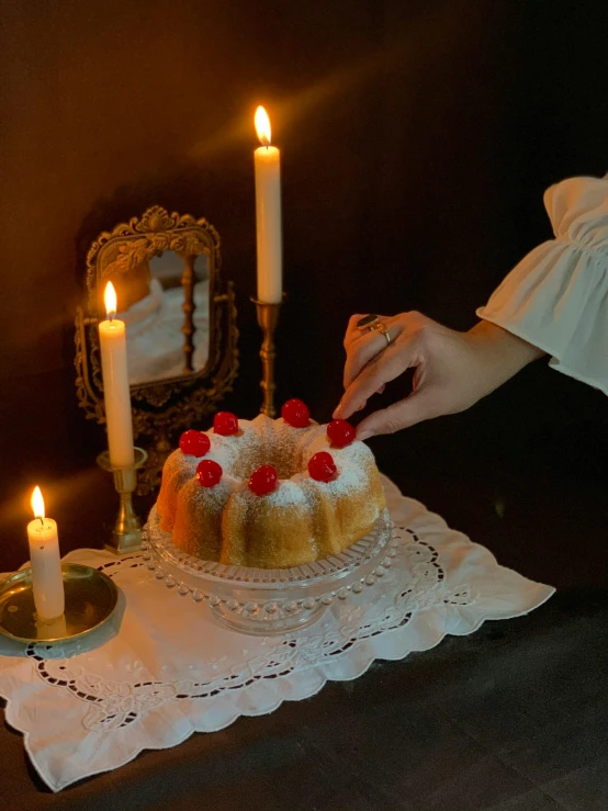 a person lighting candles on a cake on a table, inspired by Elsa Bleda, romanticism, kramskoi, 🎀 🧟 🍓 🧚, profile image, historical photo