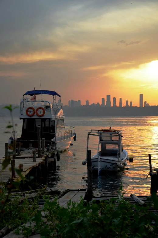 a couple of boats that are sitting in the water, a picture, by Niyazi Selimoglu, golden hour in manhattan, nature photo, today\'s featured photograph 4k, humid evening