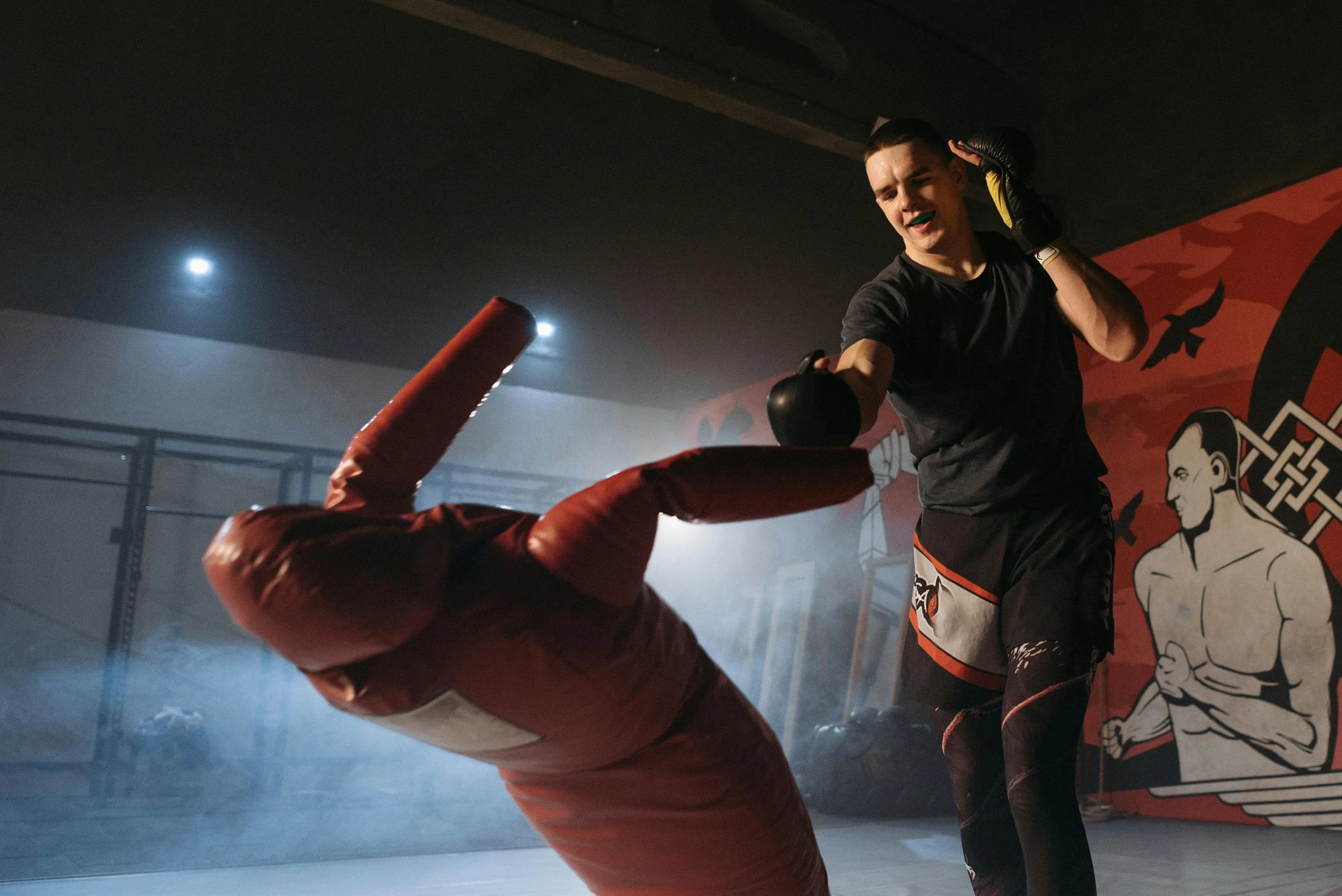 a woman standing next to a giant red object, by Julian Allen, pexels contest winner, mma southpaw stance, punching in a bag, softplay, thumbnail