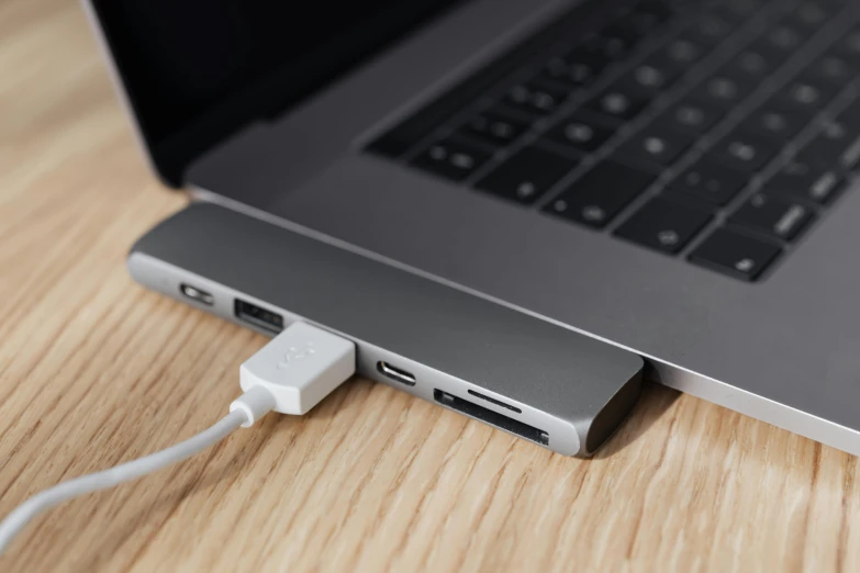 a laptop computer sitting on top of a wooden table, usb ports, grey, thumbnail, multi-part