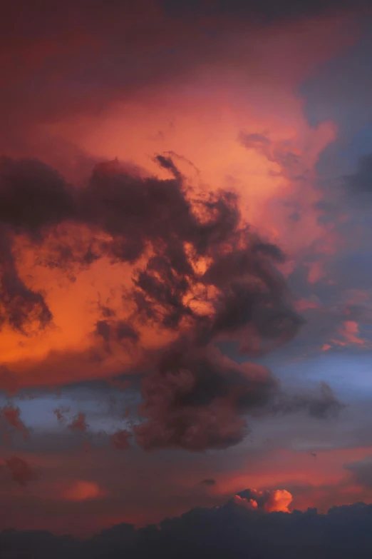 a plane flying through a cloudy sky at sunset, by Dave Allsop, romanticism, dramatic sunset nebula, devils, ..', overcast