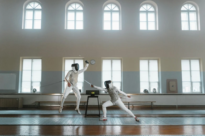 a couple of people standing on top of a wooden floor, arabesque, fencing, white, schools, unsplash photo contest winner