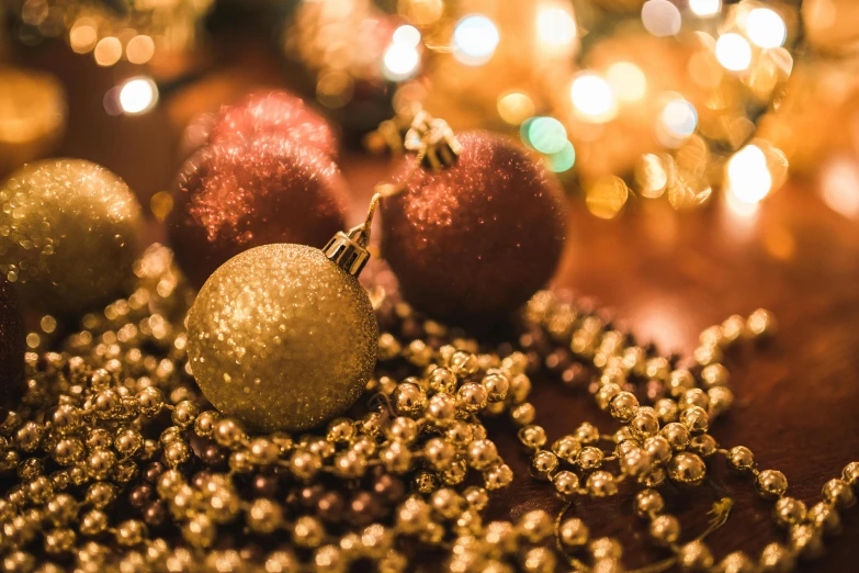 a close up of christmas ornaments on a table, by Julia Pishtar, pexels, renaissance, pearls and gold chains, brown red and gold ”, evening mood, thumbnail