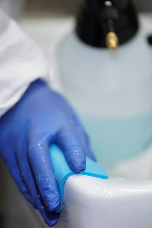 a person in blue gloves cleaning a toilet, on a advanced lab, silicone skin, thumbnail, kek