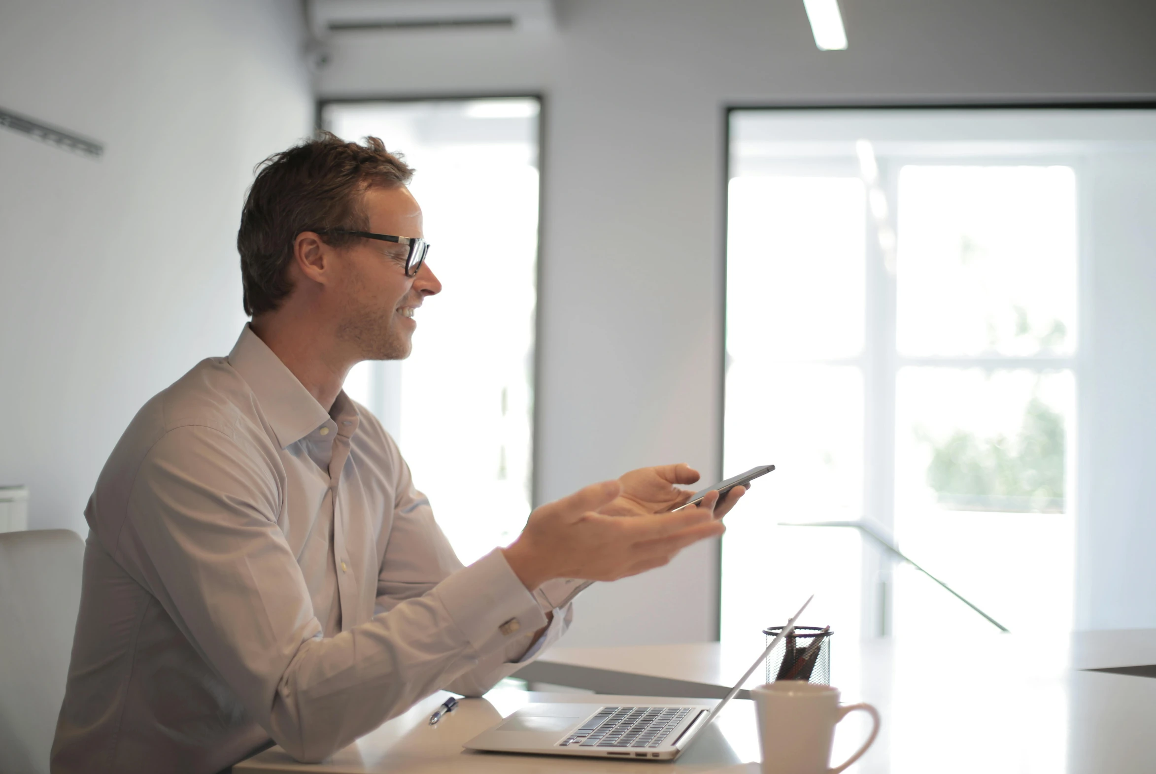 a man sitting at a table using a cell phone, profile image