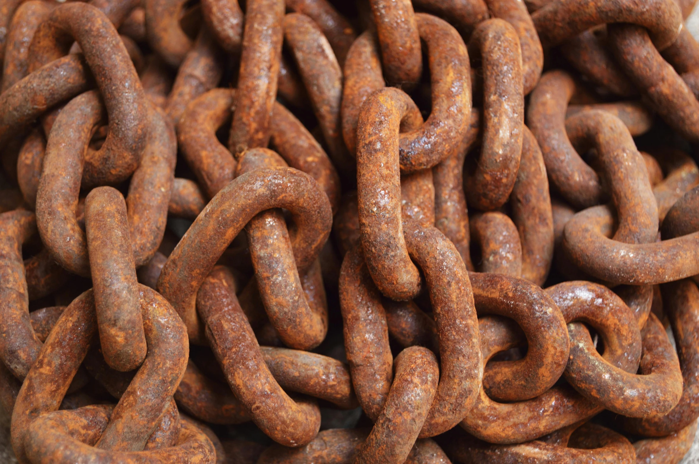 a pile of rusty chains sitting on top of a table, detailed product image, red iron oxide, old english, sausages