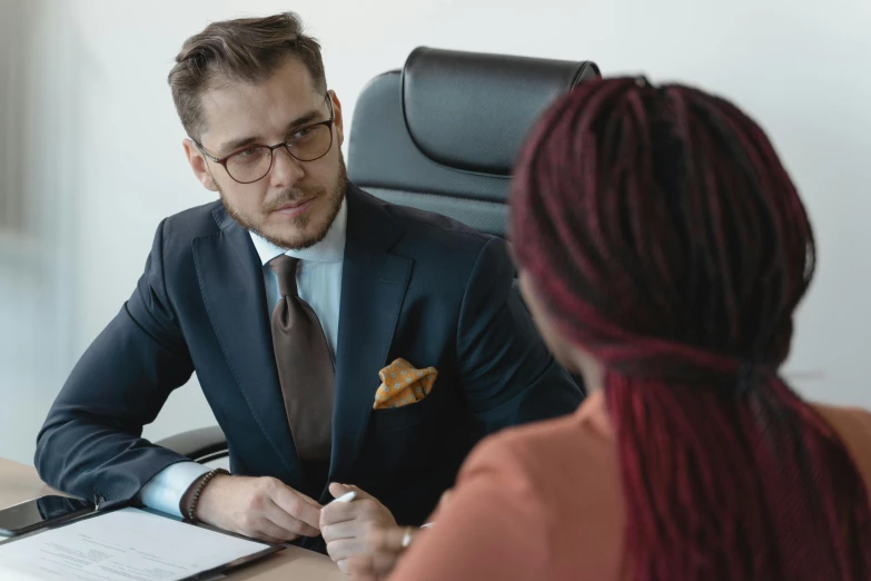 a man in a suit sitting at a desk with a woman, pexels contest winner, hurufiyya, avatar image, high resolution image, lachlan bailey, high quality image