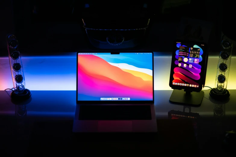 a laptop computer sitting on top of a desk, by Matt Cavotta, light and space, colored gel lighting, amoled wallpaper, thin glowing devices, bay area