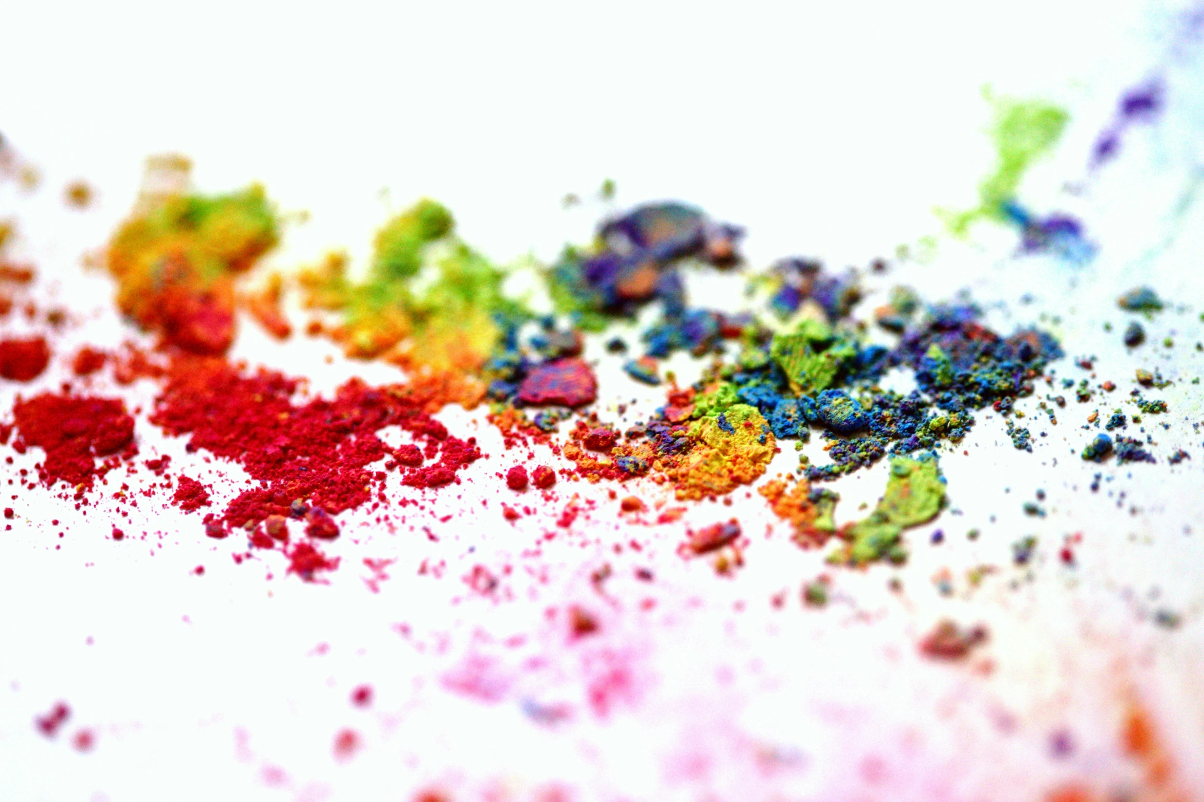 a close up of colored powder on a white surface, by Emma Geary, pexels, colorised, with a white background, colorful adornments, illustration iridescent