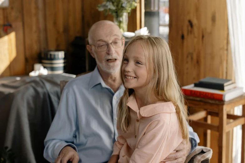 a little girl sitting next to an older man, pexels contest winner, grayish, avatar image, high quality image, teenager girl