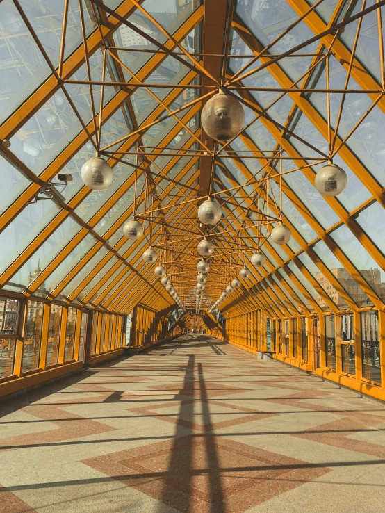 a walkway that has a lot of lights on it, inspired by Christo, trending on unsplash, light and space, gold and steel intricate, in moscow centre, low quality photo, skylights