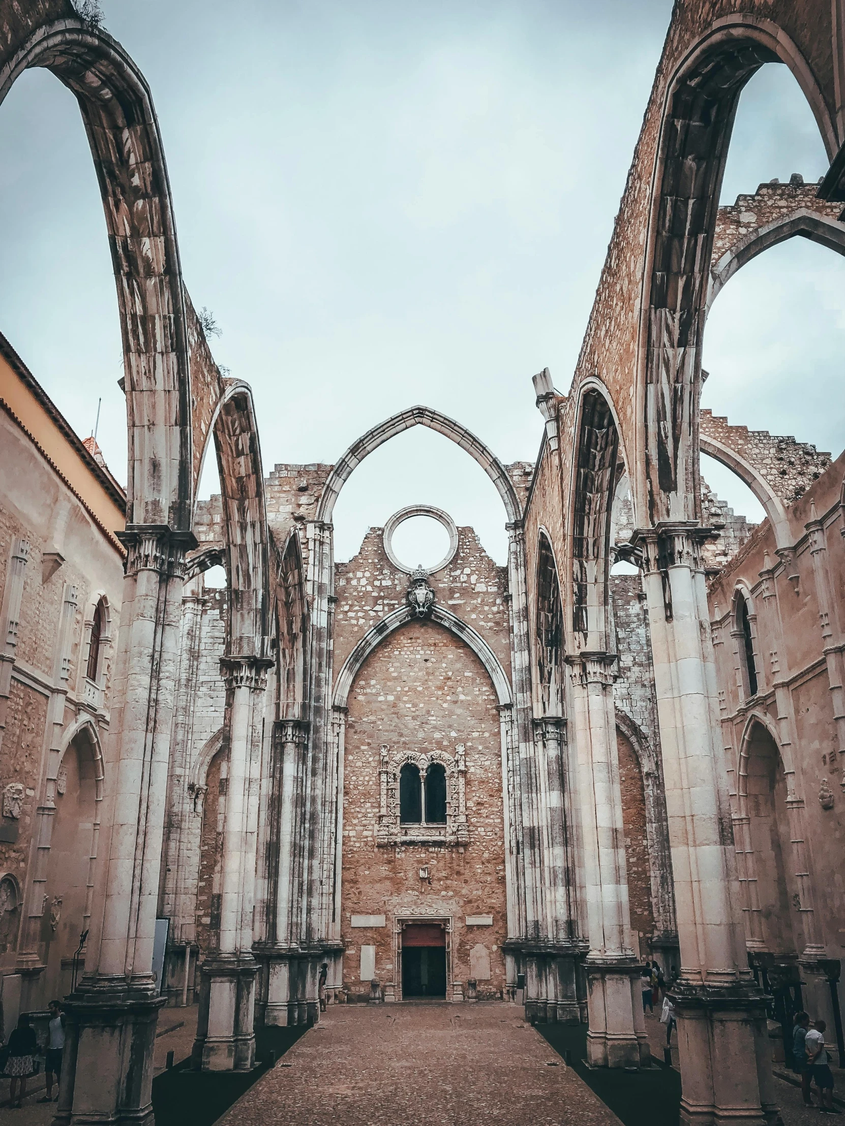 the inside of an old church with arches, a photo, by Matteo Pérez, pexels contest winner, outdoors ruined cityscape, pink, arrendajo in avila pinewood, examining ruins
