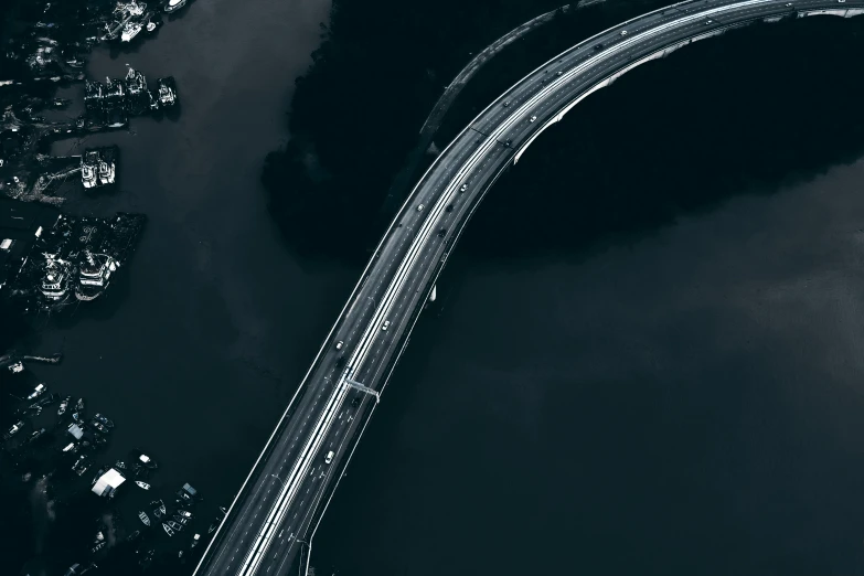 a black and white photo of a bridge over a river, by Adam Marczyński, pexels contest winner, satellite view, accurate roads, album cover, floating vehicles