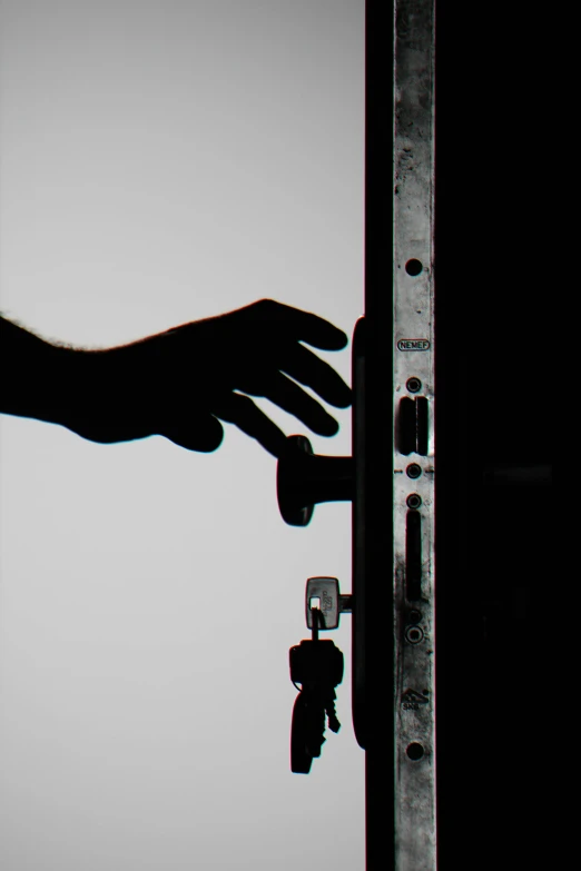 a close up of a person's hand opening a door, inspired by Robert Mapplethorpe, unsplash, conceptual art, silhouette :7, hardware, profile image, concerned