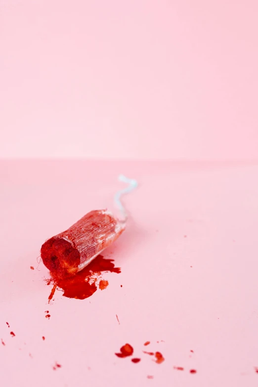 a bottle of blood sitting on top of a pink surface, by Sara Saftleven, hurt, crack pipe, jelly, cruelty