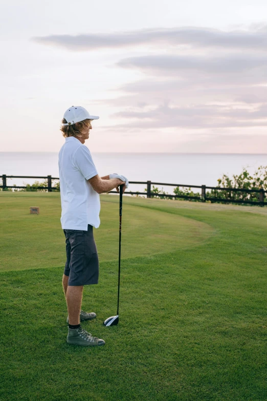 a man standing on top of a lush green field, wrx golf, ocean view, grey, thumbnail