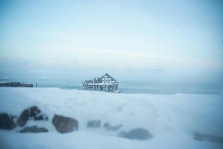 a pier covered in snow next to a body of water, by Tobias Stimmer, pexels contest winner, hazy fog, mining outpost, shot on hasselblad, arctic fish