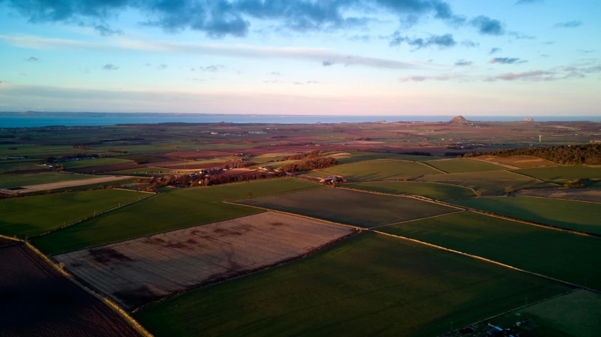 a view of the countryside from a hot air balloon, by Julian Allen, pexels contest winner, land art, evening light, skye meaker, wide view of a farm, views to the ocean