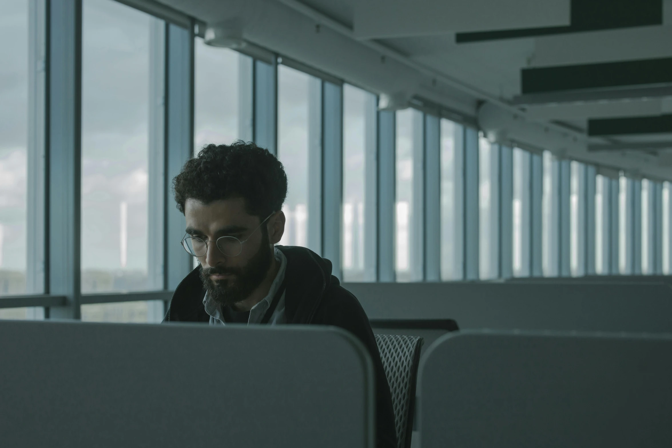 a man sitting at a desk with a laptop in front of him, pexels contest winner, serial art, 2 0 2 1 cinematic 4 k framegrab, working in a call center, hasan piker, slight overcast