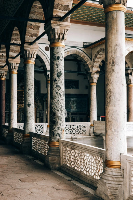 the inside of a building with columns and arches, inspired by Osman Hamdi Bey, trending on unsplash, patio, damascus, terrazzo, grey