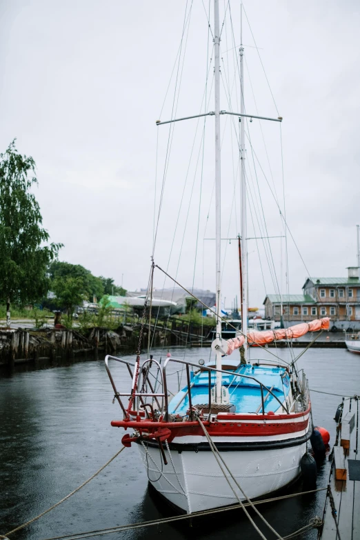 a boat that is sitting in the water, inspired by Wilhelm Marstrand, unsplash, docked at harbor, standing on the mast, canal, slight overcast