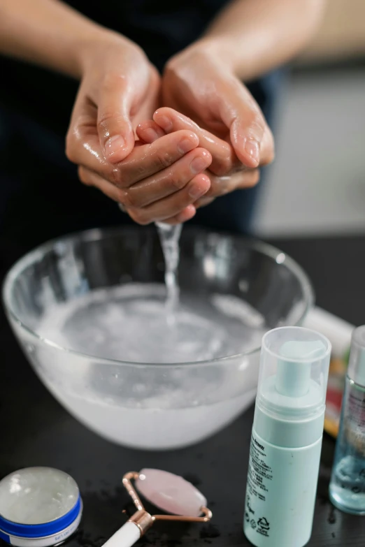 a person washing their hands in a bowl, bubbling liquids, silicone skin, sprays, consistent face