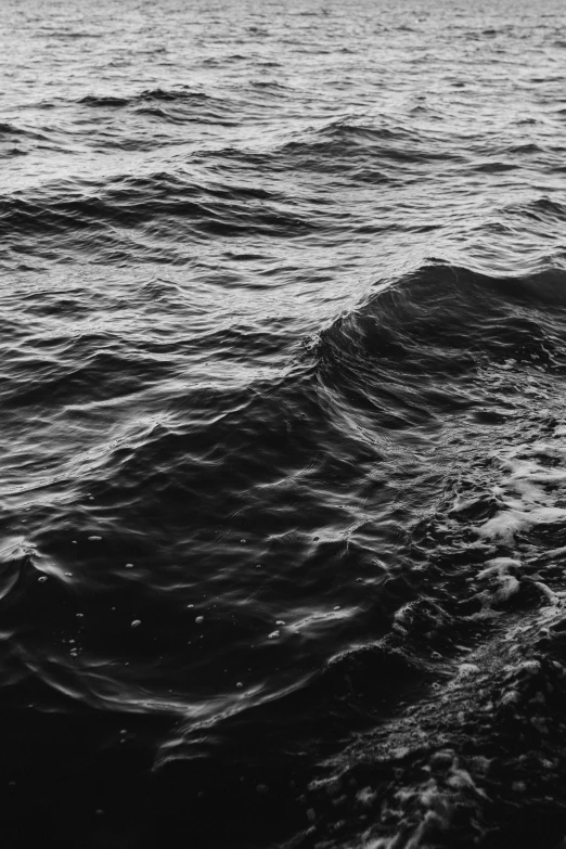 a black and white photo of a body of water, a black and white photo, unsplash, lyrical abstraction, ((waves, concerned, dark ocean, deeply detailed