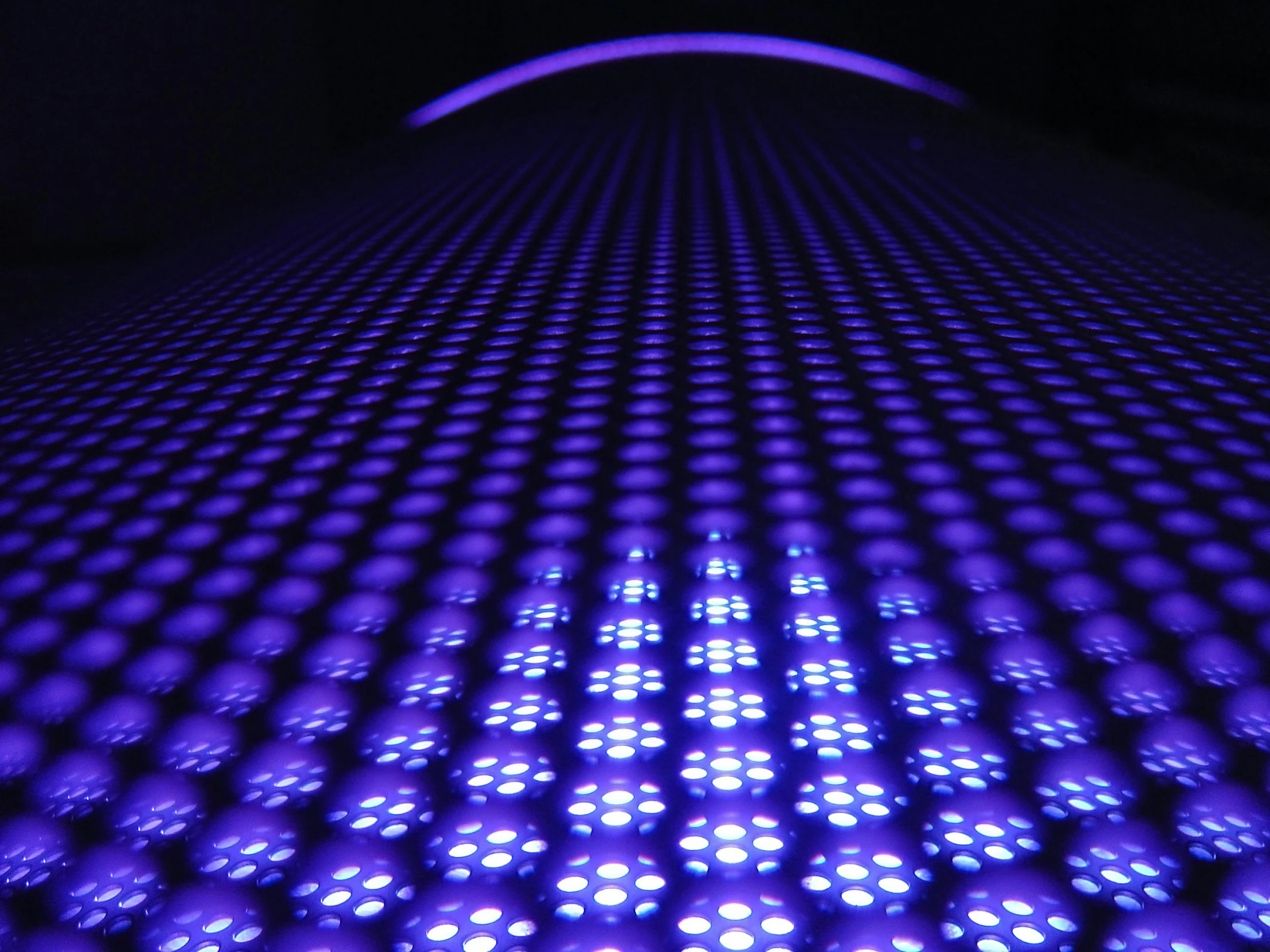 a close up of a blue light in a room, made of dots, purple volumetric lighting, graphene, light casting onto the ground