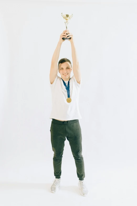 a boy holding up a trophy in front of a white background, by Jacob Toorenvliet, pexels contest winner, full body photo of steve, 15081959 21121991 01012000 4k, greta thunberg, gold medal