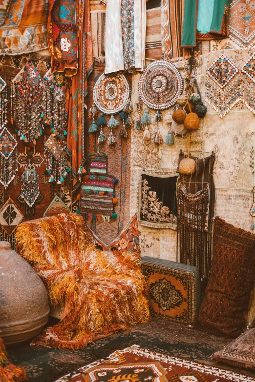 a room filled with lots of different types of rugs, a cross stitch, inspired by Riad Beyrouti, trending on pexels, ornate jewels, old jeddah city street, brown and cyan color scheme, glittering