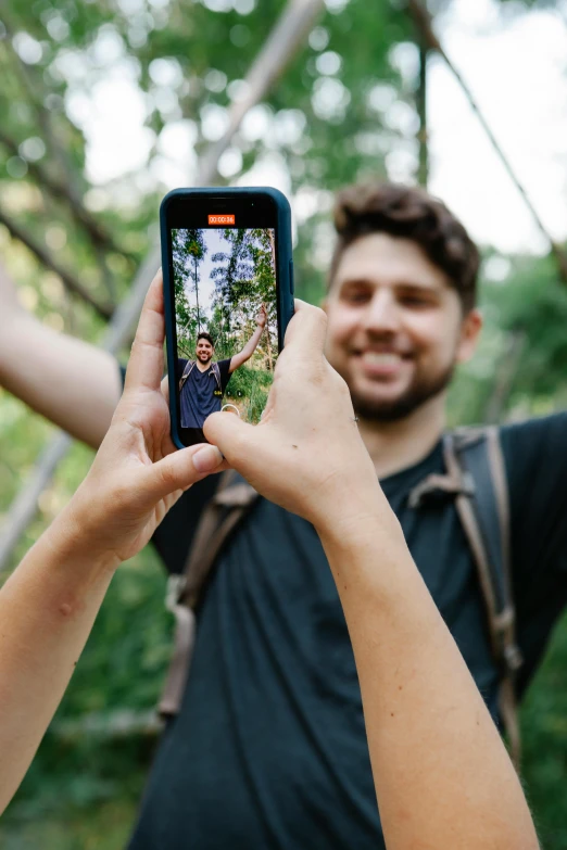 a man and a woman taking a picture of themselves, trending on pexels, standing in a forest, digital still, vine, half image