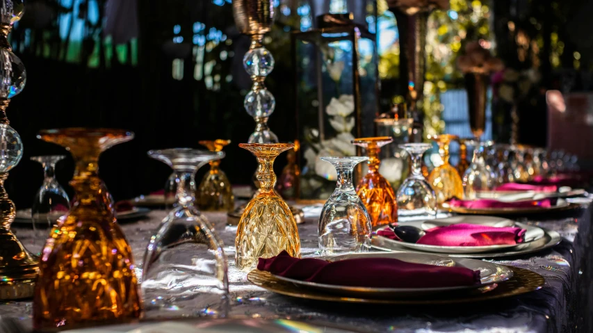 a close up of a table with plates and glasses, by Julia Pishtar, arabian nights inspired, amber glasses, garden setting, elaborate polished