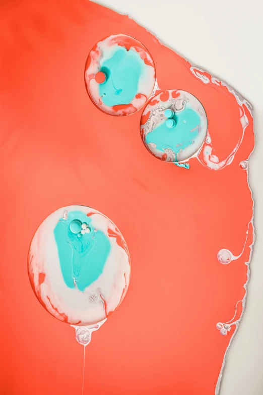 a close up of a cake with icing on it, inspired by Lucio Fontana, trending on unsplash, abstract art, vermillion and cyan, made of liquid, portholes, silicone skin