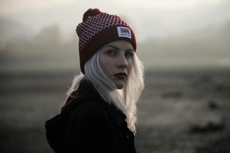 a woman with white hair wearing a red hat, inspired by Elsa Bleda, unsplash contest winner, wearing a beanie, portrait rugged girl, outlive streetwear collection, cinematic front shot